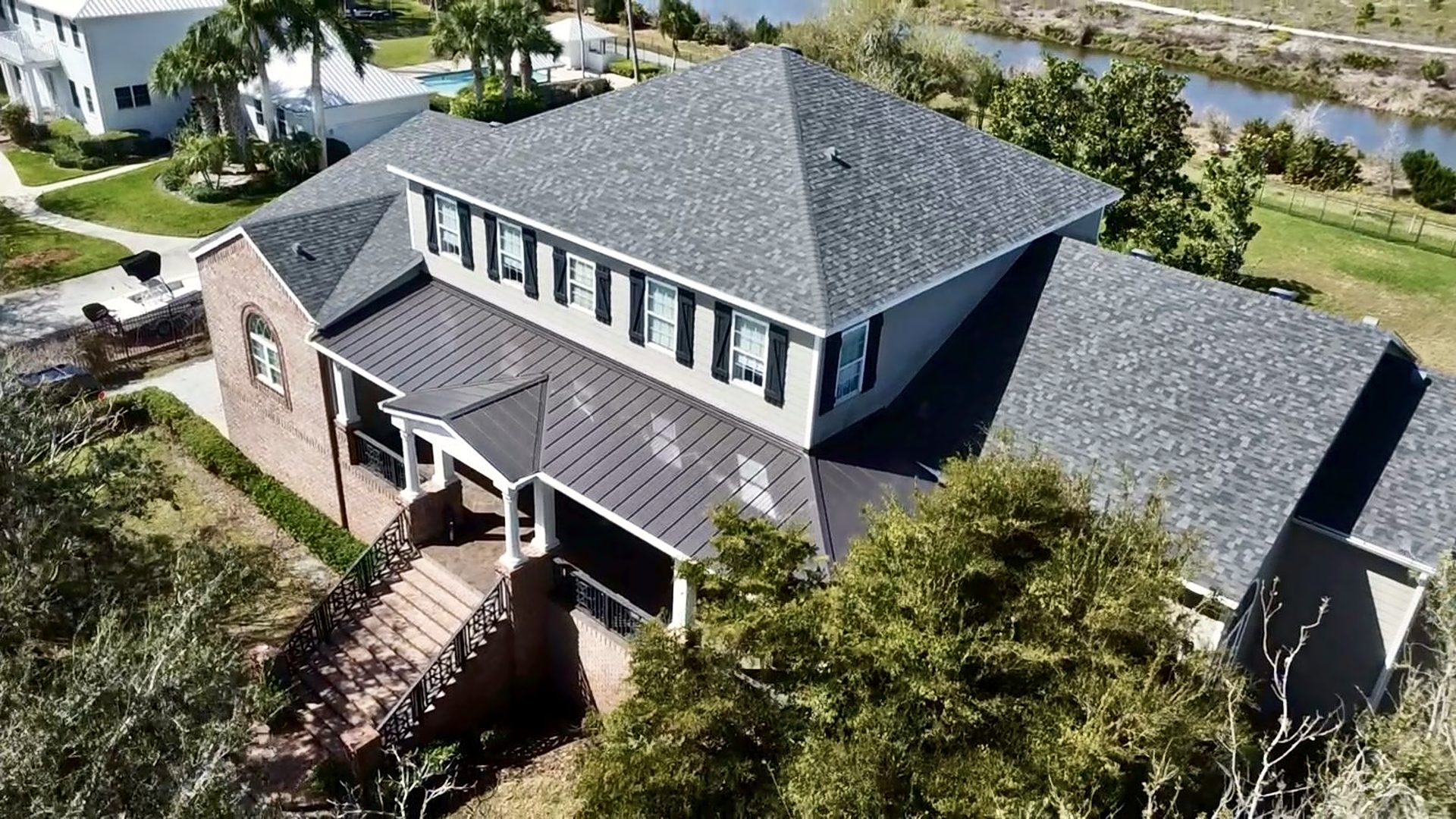 Aerial view of a completed shingle and standing-seam metal roof replacement
